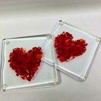 pair of clear glass coaster with red hearts
