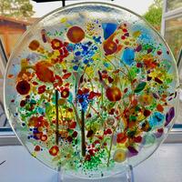 Circular glass panel with flowers