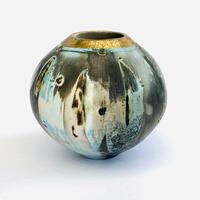 Smoke-fired vessel with blue and gold.