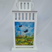 Large lantern showing summer fields and butterfly