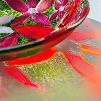 Medium glass bowl with red flowers and reflection