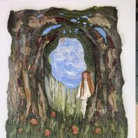 felted picture of woman in front of trees