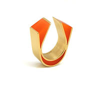 U.F.O Banded. Gold plated sterling silver and glowing orange resin ring from the U.F.O, Unique Finger Ornaments, collection. The U.F.O collection is inspired by the forms, structures and colours of precious and semi-precious stones in their natural forms. . 
