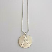A satin and highly polished finished pendant