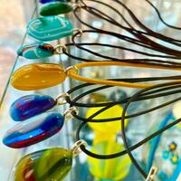Fused glass necklaces on faux leather.