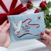 A keepsake Valentines envelope gift embroidered with a white dove and custom message by Kate Sproston Design