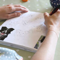 Kate Sproston drawing collie motifs in her sketchbook