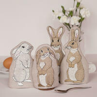 A set of four linen egg cosies embroidered with rabbits by Kate Sproston Design