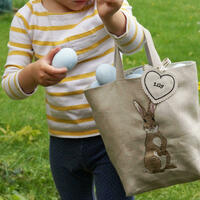 A linen easter egg hunting bag embroidered with a rabbit by Kate Sproston Design