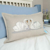 Embroidered cushion featuring a family of swans by Kate Sproston Design