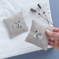 A set of two linen lavender sachets embroidered with swans by Kate Sproston Design