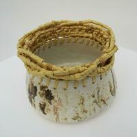 Stoneware pot with raffia weaving