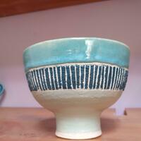 Small white stoneware footed bowl with striated band