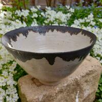 Upright stoneware footed bowl with manganese rim