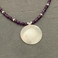 Silver swirls pendant and amethyst bead necklace