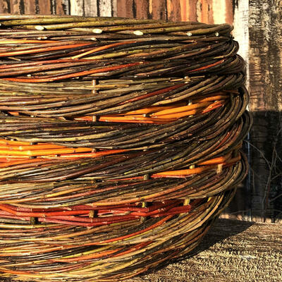 Close up of Large Willow Basket Rope Coil Weave Natural Colours Warwickshire Willow Handmade Red Orange Brown Warm Hues Contemporary