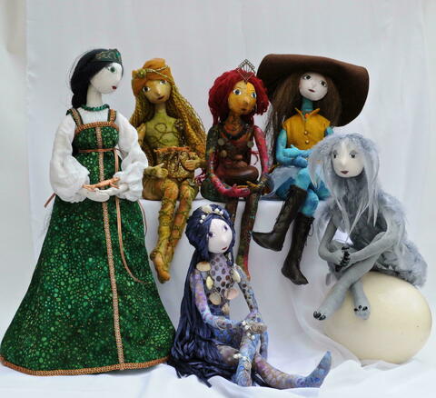 A group of colourful textile art dolls