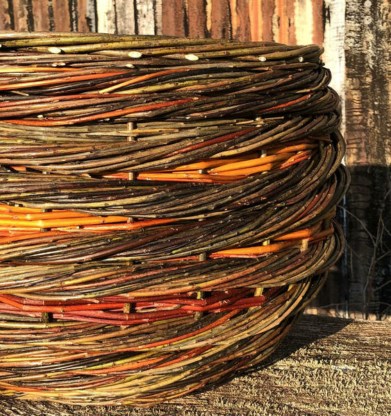 Close up of Large Willow Basket Rope Coil Weave Natural Colours Warwickshire Willow Handmade Red Orange Brown Warm Hues Contemporary