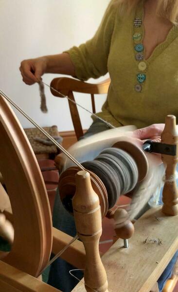 Spinning hand prepared  wool from my sheep 