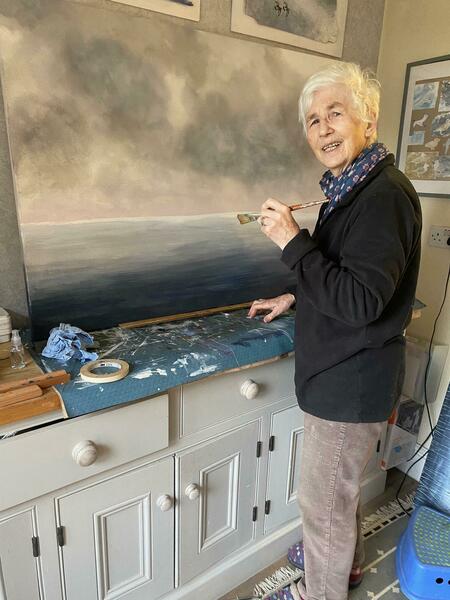 Working on a large seascape, flying birds
