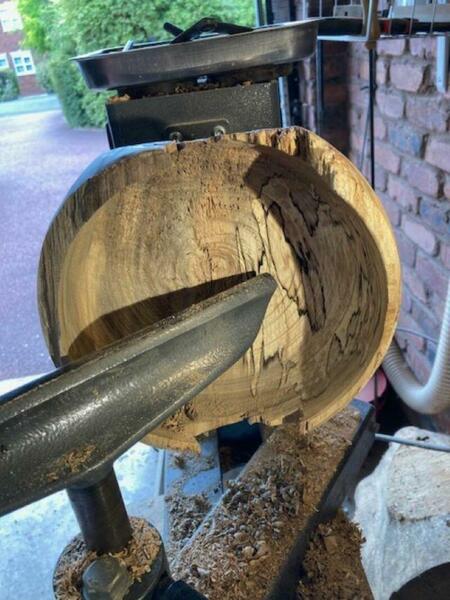 Part completed spalted beech bowl on lathe.