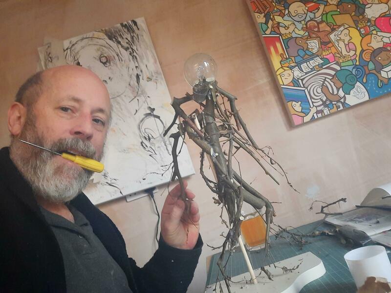 James Robinson, Coventry based mixed media artist, building running figure sculpture from found twigs and light bulbs