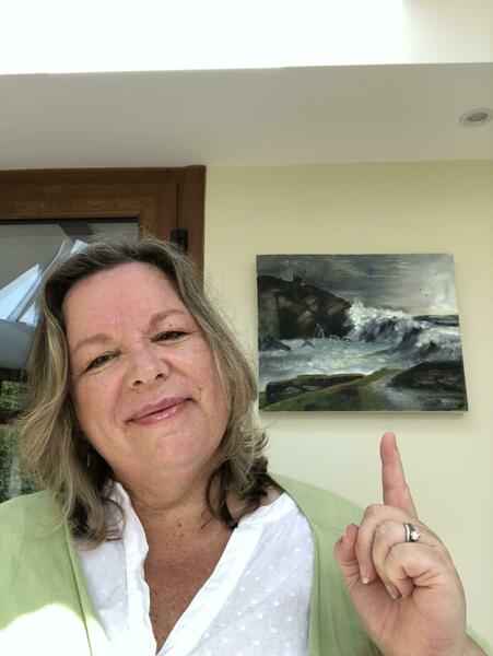 Jane Powell Artist with painting of Cadgwith Cove