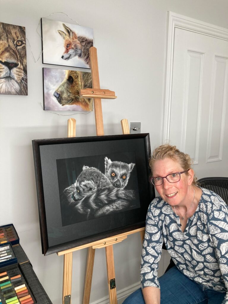 Artist Louise Hancox with lemur artwork in her studio