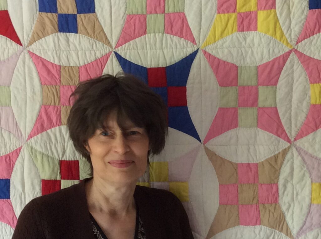 Jane Cobbett with a vintage patchwork quilt