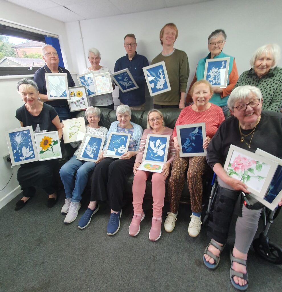 Members of Painting for Pleasure Art Group with their artwork