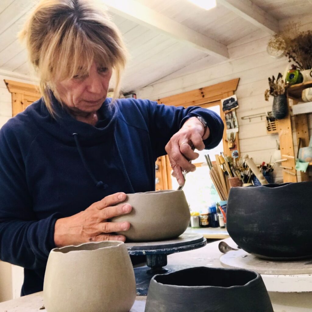 @nicolarichardsceramics at work in her garden studio