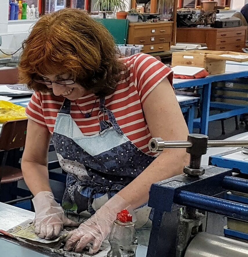Janet inking up a printing plate