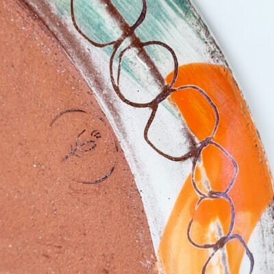 Plate detail - High fired slip decorated earthenware