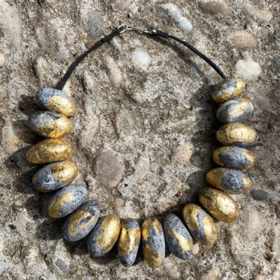 Necklace made from adapted papiermache with gold leaf. Handmade silver clasp.